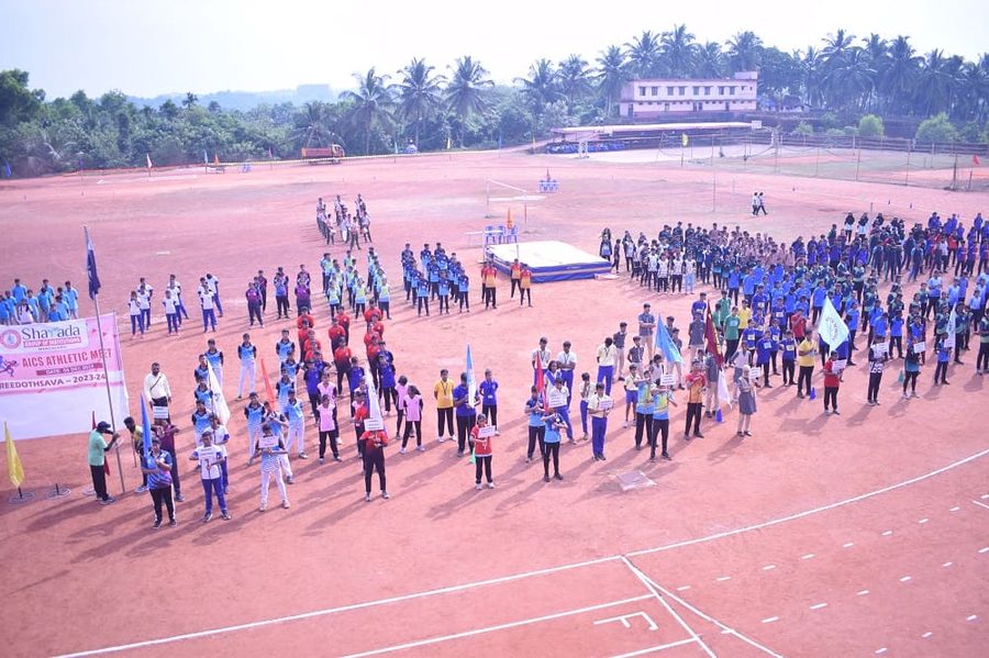 Students lined up on the ground for the sports meet march past